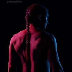 abby's muscular back lit eith pink and blue