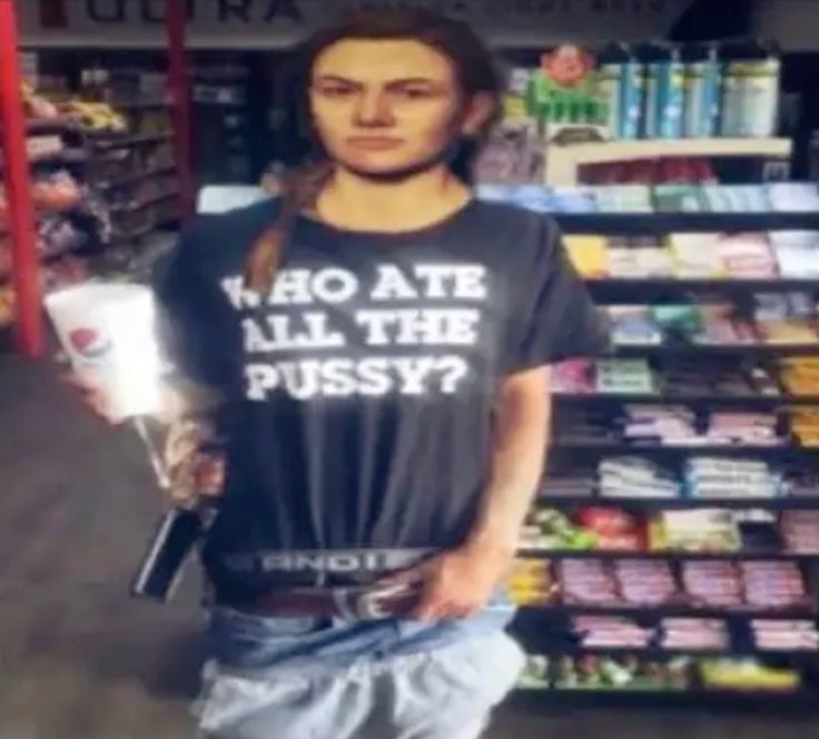 an edited camera footage photo of abby in a corner shop with a tshirt reading 'who ate all the pussy'